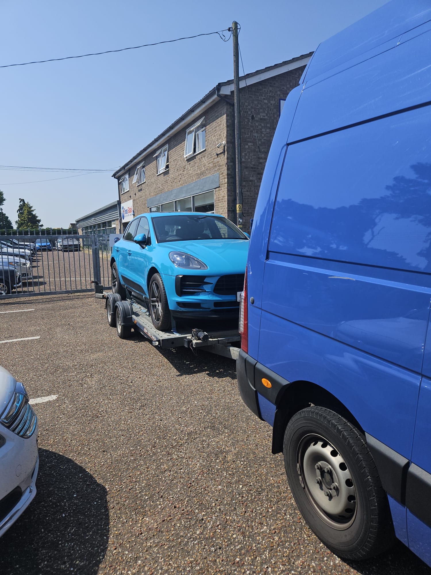 Blue Porsche transported on a trailer