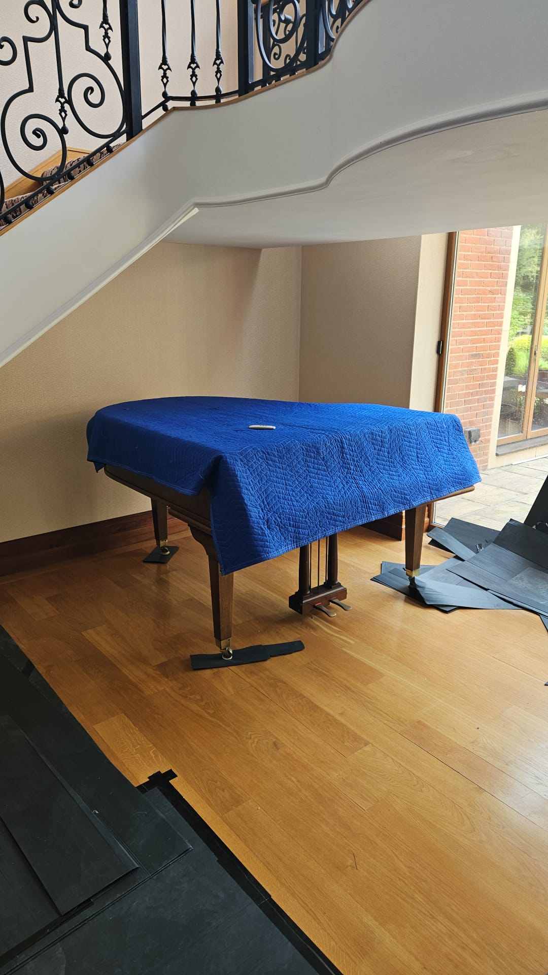 Full size grand piano getting ready to be moved